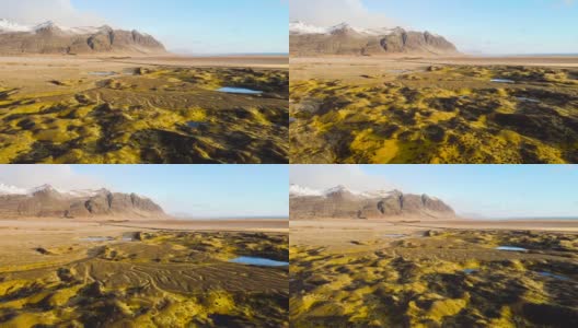 神奇的空中飞行在冰岛上空，从鸟瞰，这里是一片有着绿色苔藓和蓝绿色湖泊的火山景观。美丽而原始的自然高清在线视频素材下载