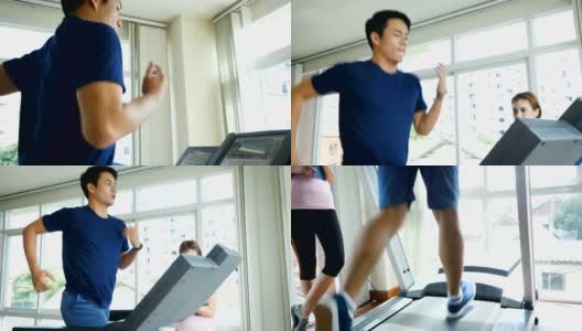 年轻的健身男子在跑步机上跑步，在健身房和女教练锻炼，健康的生活方式和有氧训练的概念高清在线视频素材下载