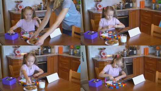 女孩在家里玩积木，还吃着饼干高清在线视频素材下载