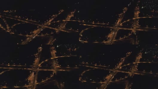 航拍:临近郊区的大型多层次立交桥在晚上亮起了灯高清在线视频素材下载