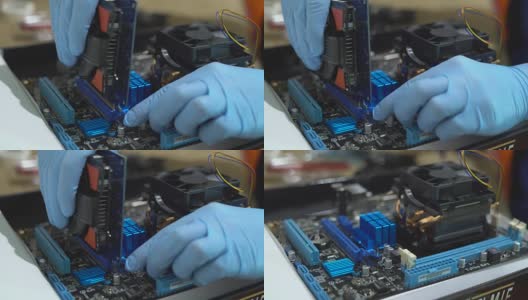 一个戴着蓝色乳胶手套的男人收集芯片。现代计算机的生产。一个人的手设置了达利。FullHD高清在线视频素材下载
