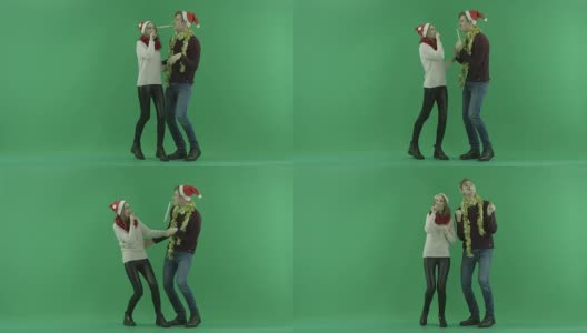 年轻快乐的夫妇庆祝圣诞节和跳跃一起与色度键的背景高清在线视频素材下载