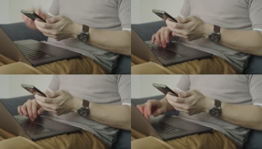 年轻的亚洲男人的手用智能手机和笔记本电脑使用信用卡网上购物休闲装。高清在线视频素材下载