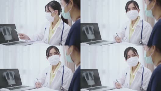 女医生一边讲解，一边给病人看片上的x光片。高清在线视频素材下载