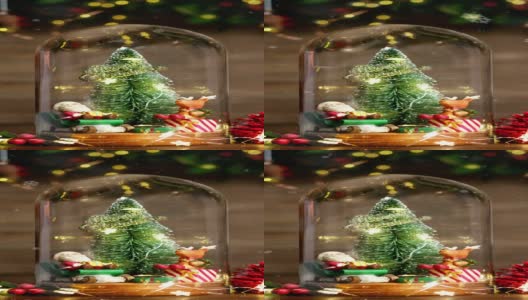 垂直圣诞快乐和新年快乐圣诞树和圣诞老人在玻璃圆顶装饰小驯鹿，松果金箔在木材背景高清在线视频素材下载