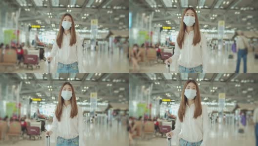 年轻的女游客在机场散步，戴着口罩，慢镜头高清在线视频素材下载