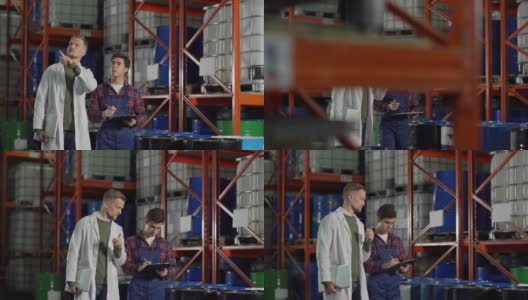 身着白大褂的中年工程师在工业仓库中行走时指导年轻的物料搬运员做笔记的慢动作跟踪镜头高清在线视频素材下载