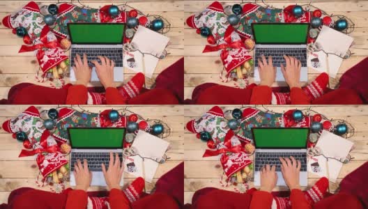 女孩用电脑打圣诞贺词。高清在线视频素材下载