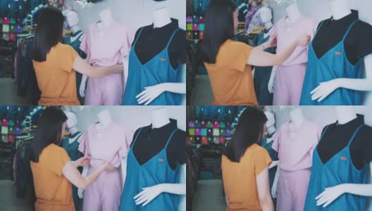 女顾客在商店里挑选衣服高清在线视频素材下载