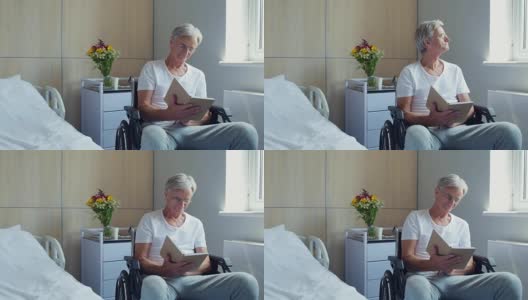 一位和蔼的老人正在医院病房里看书高清在线视频素材下载