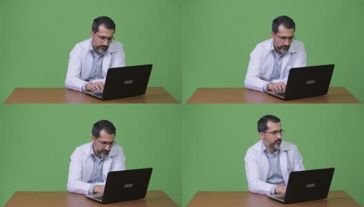 英俊的波斯胡子男子医生使用笔记本电脑高清在线视频素材下载