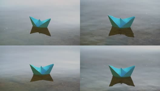 蓝色的纸船在浪漫的日落水上航行。高清在线视频素材下载