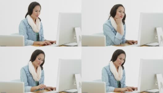 亚洲女性使用笔记本电脑和电脑在办公桌前工作高清在线视频素材下载