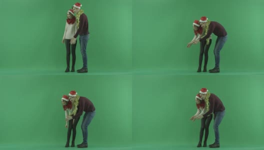 戴着圣诞帽的弟弟和妹妹需要一只宠物，背景上有色度键高清在线视频素材下载