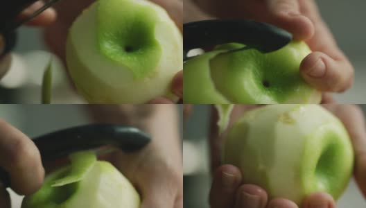 一个女人的手剥一个绿色苹果与蔬菜削皮器的极端特写镜头高清在线视频素材下载