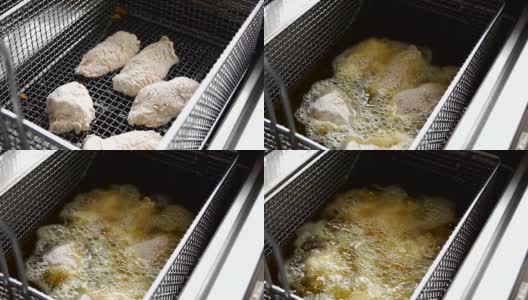 烹饪油炸面包屑鸡。在热油炸锅里炸鸡块的特写高清在线视频素材下载