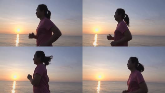 SLO MO美丽的年轻亚洲女子在沙滩上跑步高清在线视频素材下载