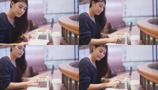 美丽的亚洲女人在电脑上工作在咖啡馆高清在线视频素材下载