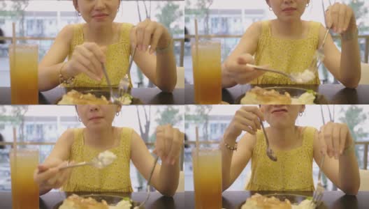 亚洲女人在咖啡馆吃蜂蜜吐司假日，周末高清在线视频素材下载