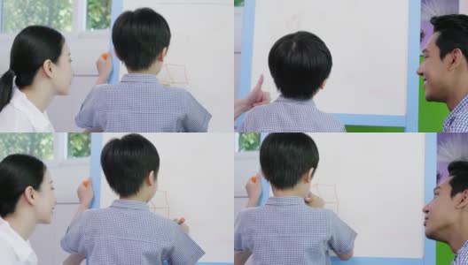 亚洲家庭的生活方式父母和儿子在家里通过在白板上创作艺术来进行教育活动。创造微笑和乐趣。高清在线视频素材下载