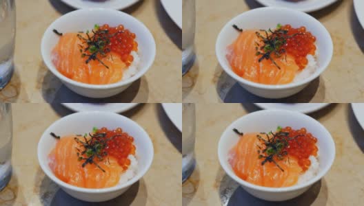 一碗新鲜三文鱼，红鱼子酱和米饭。日式健康食品高清在线视频素材下载