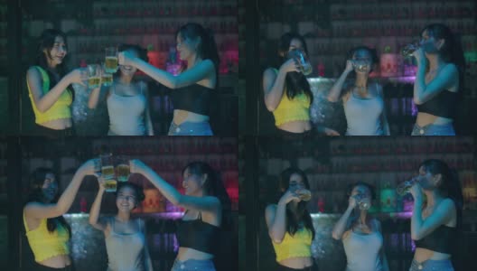 一群年轻的亚洲女人跳舞的朋友享受夜晚的派对。高清在线视频素材下载