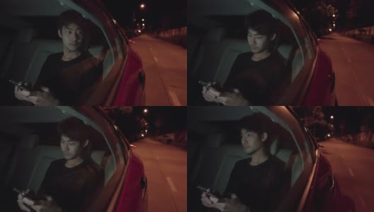 晚上坐在汽车后座上用智能手机打字的帅哥高清在线视频素材下载
