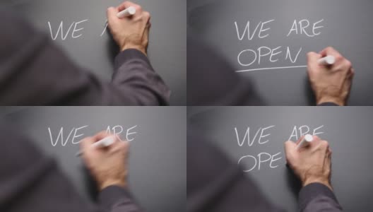 在黑板上手写“We are open”并做记号高清在线视频素材下载