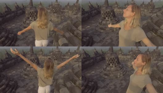 4K分辨率的视频旅行女孩拥抱日出在婆罗浮屠寺，印度尼西亚。People discovery Asia概念高清在线视频素材下载