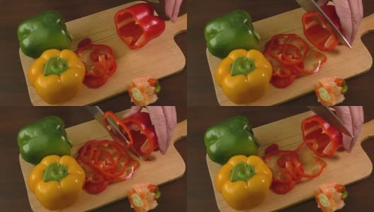 在切菜板上切甜椒，包括红、黄、绿高清在线视频素材下载