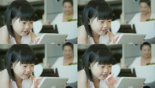 可爱的小女孩在数字平板电脑上玩游戏高清在线视频素材下载