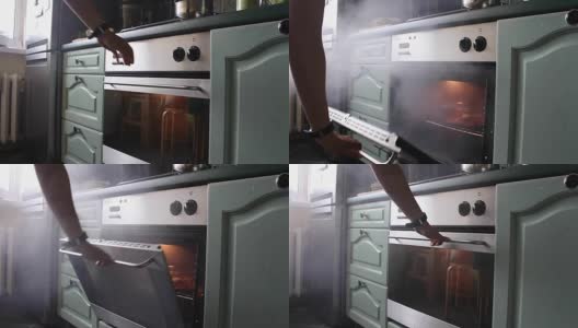 打开烤箱，烧焦的饭菜冒出烟来高清在线视频素材下载