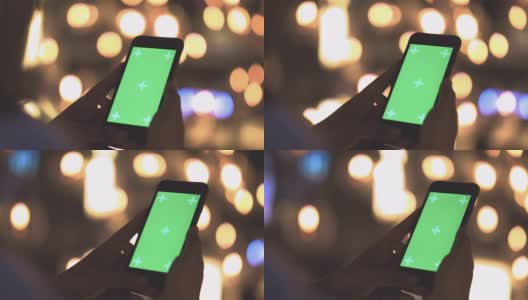 色彩之钥:在夜晚的城市里拿着智能手机的女人高清在线视频素材下载