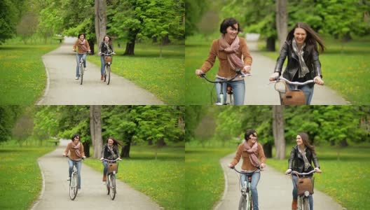 两个女性朋友在公园里骑自行车。年轻有趣的女人与自行车花时间在一起高清在线视频素材下载