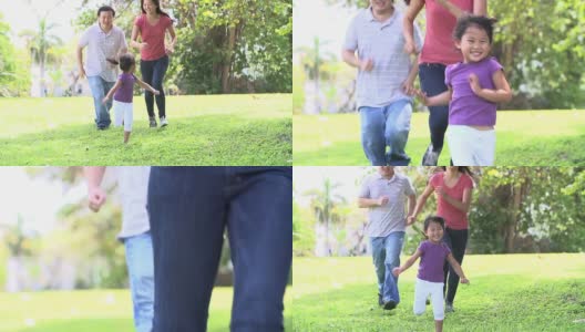 父母和女儿在公园跑步的慢镜头高清在线视频素材下载