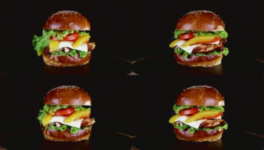 在黑色背景的木板上旋转着一个汉堡，上面有一大块肉、蔬菜和奶酪高清在线视频素材下载
