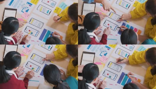 亚洲用户体验开发人员和ui设计师手头脑风暴关于移动应用界面线框设计的表颜色代码在现代办公室。创意数字发展机构高清在线视频素材下载