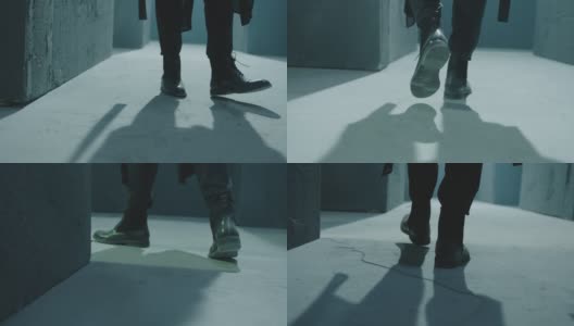 男性腿在黑色靴子的特写。在黑暗迷宫中行走的人的后视图。人走在暗室，走廊里。神秘视频的片段。拍摄在ARRI ALEXA电影摄影机在慢动作高清在线视频素材下载