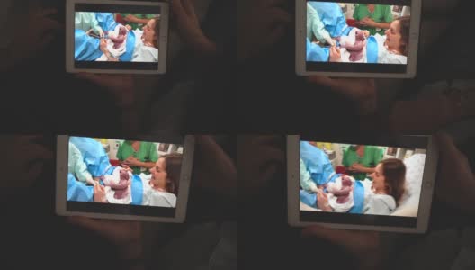 奶奶在打视频电话，看着她的孙子在医院刚出生高清在线视频素材下载