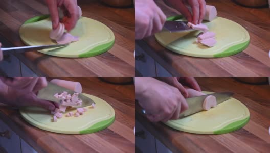 用一把锋利的刀子在厨房架子上的厨房板上把香肠切成小块高清在线视频素材下载