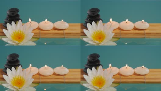 平衡卵石的石头，小蜡烛和白莲莲的荷花高清在线视频素材下载