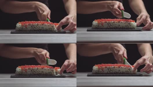 厨师用锋利的刀将寿司卷切成小块。寿司的制作、制作过程。日本料理高清在线视频素材下载