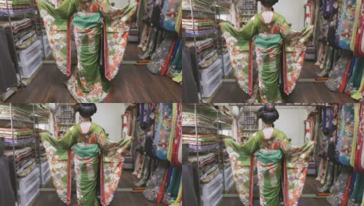舞妓(正在训练的艺妓)在试衣间里穿着华丽的绿色和服高清在线视频素材下载