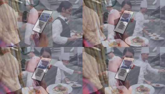 一名女性在餐厅厨房里拿着防疫护照的智能手机高清在线视频素材下载