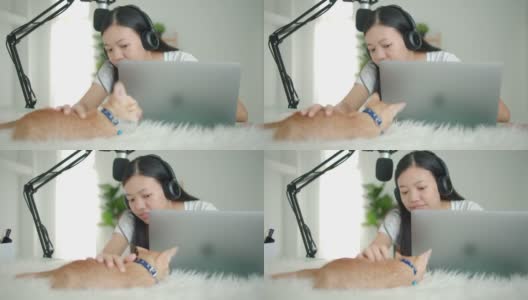 亚洲女学生或女商人远程工作与电脑和小猫。社交距离概念在covid-19疫情下独自在家工作。高清在线视频素材下载