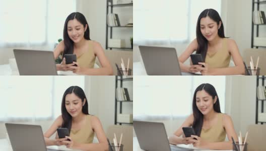 年轻的亚洲美丽的女商人使用智能手机。微笑迷人快乐的年轻女性短信触摸展示手机。高清在线视频素材下载