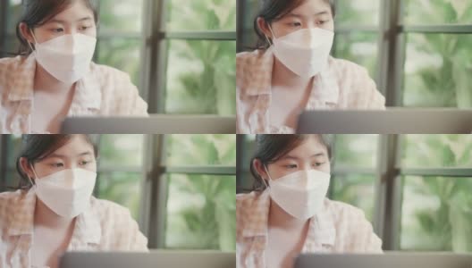 亚洲少女戴着面具盯着笔记本电脑屏幕高清在线视频素材下载