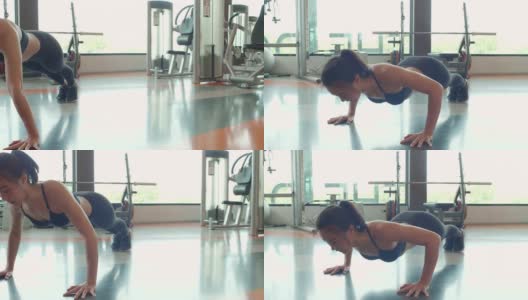 肖像亚洲健身妇女做推举运动在体育健身房的背景。人的生活方式和运动理念。在地板上保持身体平衡的女运动员。女孩在运动服装高清在线视频素材下载
