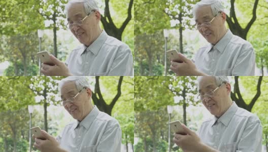 中国老人在公园里使用智能手机高清在线视频素材下载