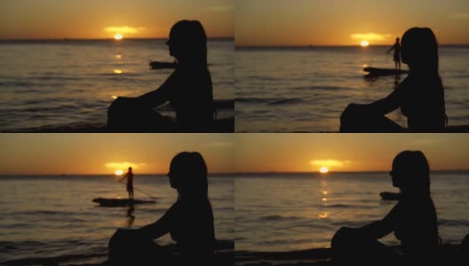 日落时分沙滩上一个女人的剪影高清在线视频素材下载